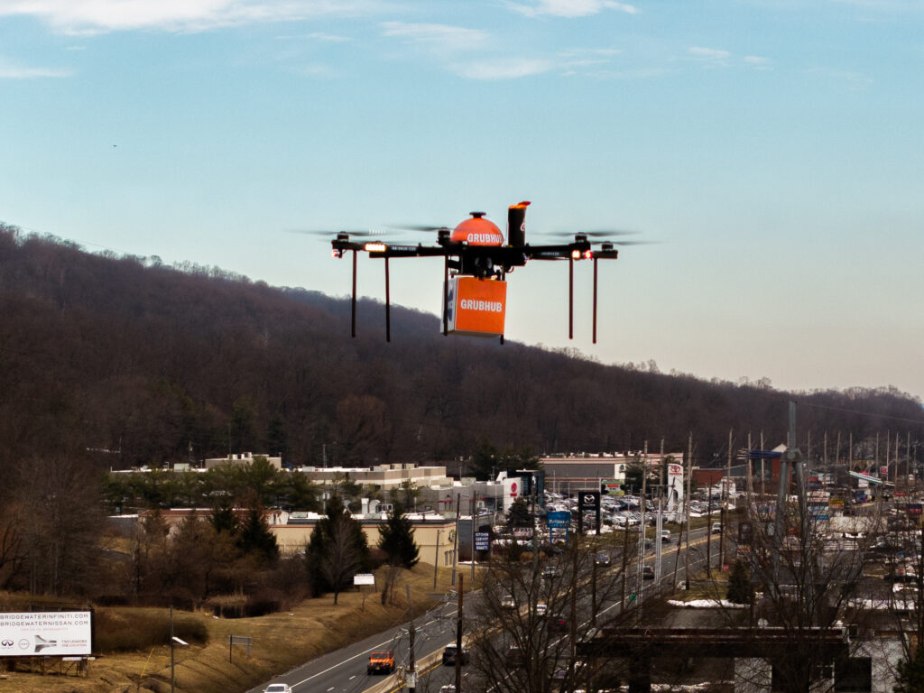 Drone Flying Over City Holding Grubhub Package
