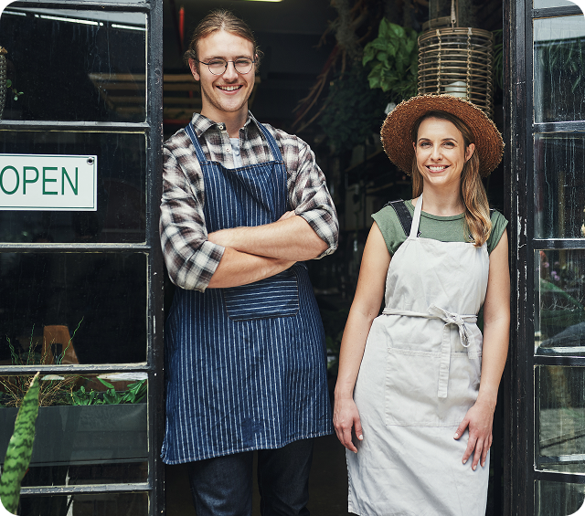 Shop Owners In Front Of Store