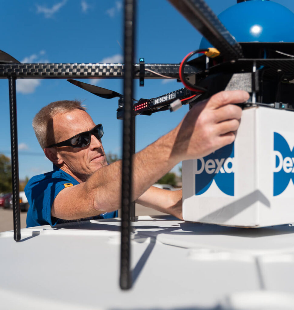 Man Loading Box On Dexa Drone